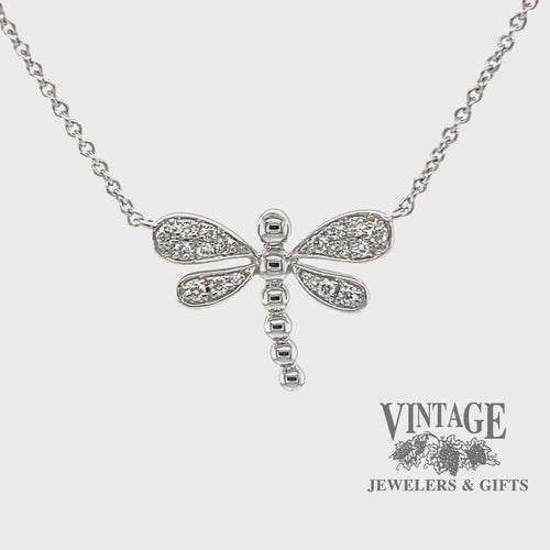 Revolving video of 14 karat white gold .14 carats total weight diamond dragonfly necklace