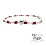 Revolving video of 14 karat white gold ruby and diamond link bracelet