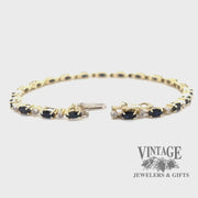 Revolving video of 10 karat yellow gold sapphire and diamond link bracelet