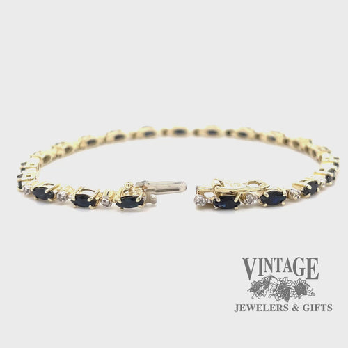 Revolving video of 10 karat yellow gold sapphire and diamond link bracelet