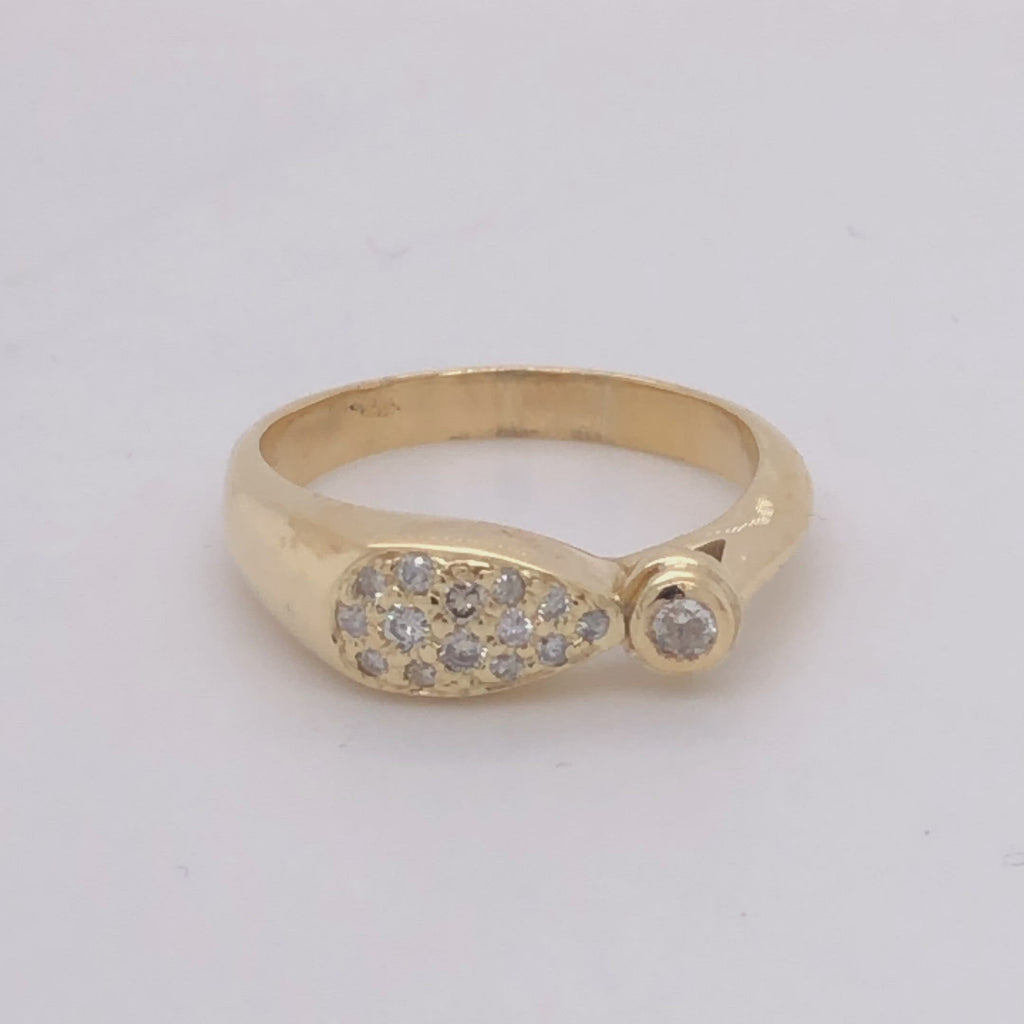18 karat yellow gold pave' diamond ring with 1 bezel set diamond