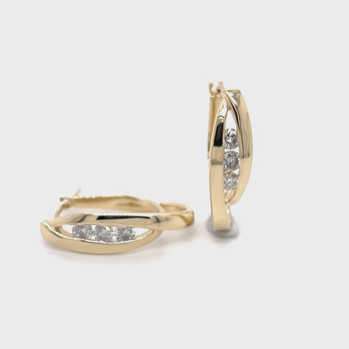 Revolving video of 14 karat yellow gold estate diamond hoops with a crossed double oval loop design