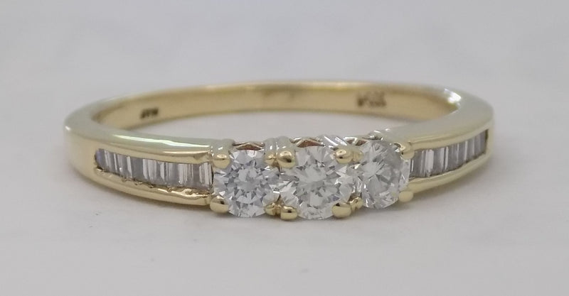 Three stone baguette shank diamond ring.
