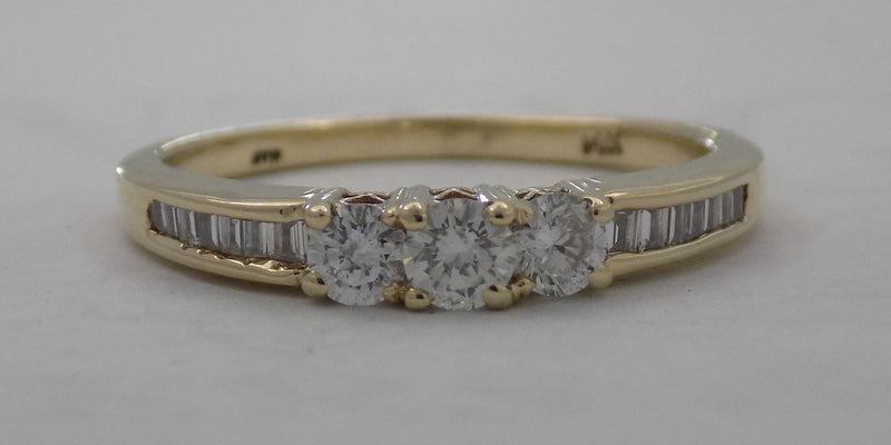 Three stone baguette shank diamond ring.