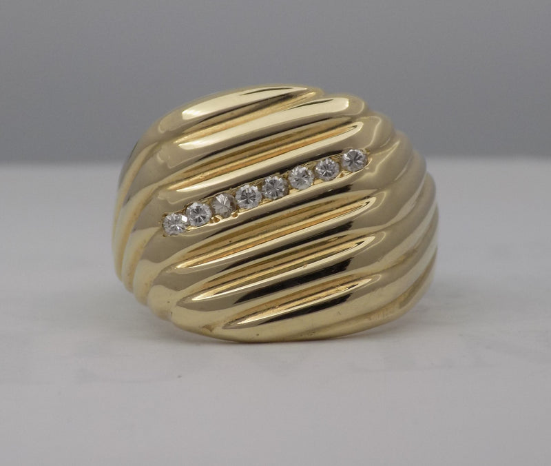 Yellow gold cushion shaped diamond signet ring.