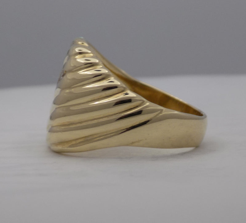 Yellow gold cushion shaped diamond signet ring.