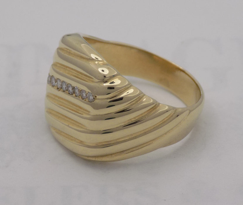 Yellow gold cushion shaped diamond signet ring.
