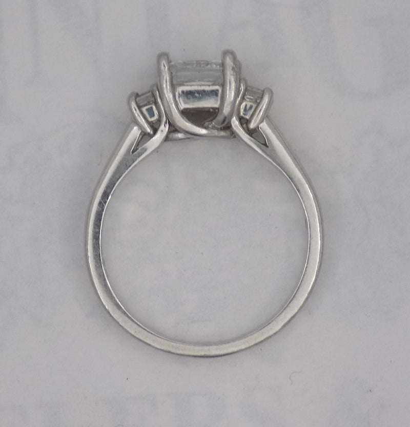 Platinum princess cut three stone ring.