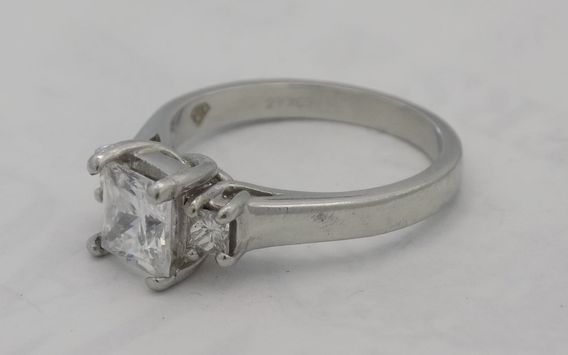 Platinum princess cut three stone ring.