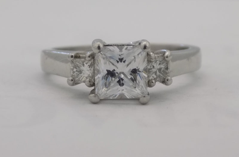 Platinum princess cut three stone ring.