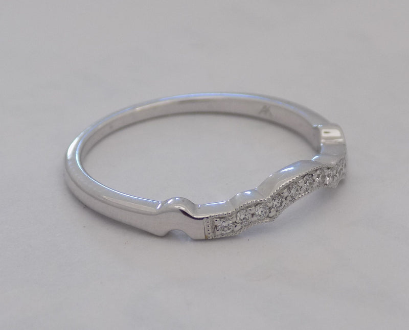 White gold curved pinpoint diamond band.