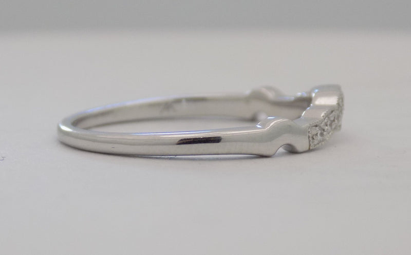 White gold curved pinpoint diamond band.