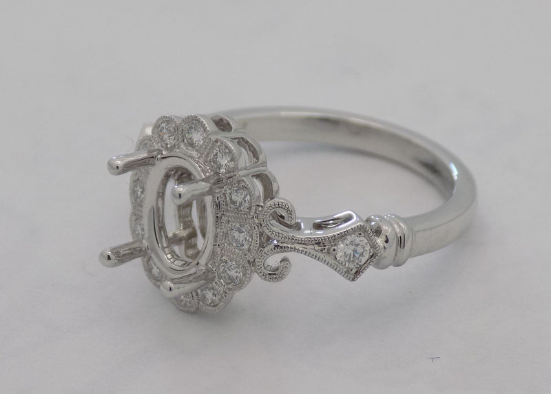 14 karat white gold diamond semi- mount for 1 carat oval diamond.