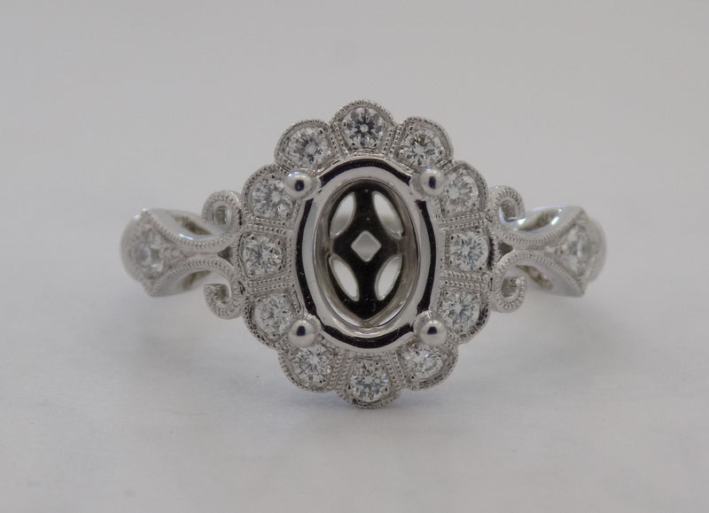 14 karat white gold diamond semi mount for 1 carat oval diamond.