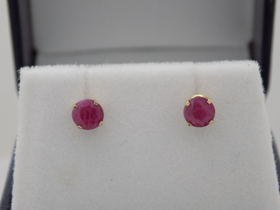 Yellow gold ruby solitaire stud earrings