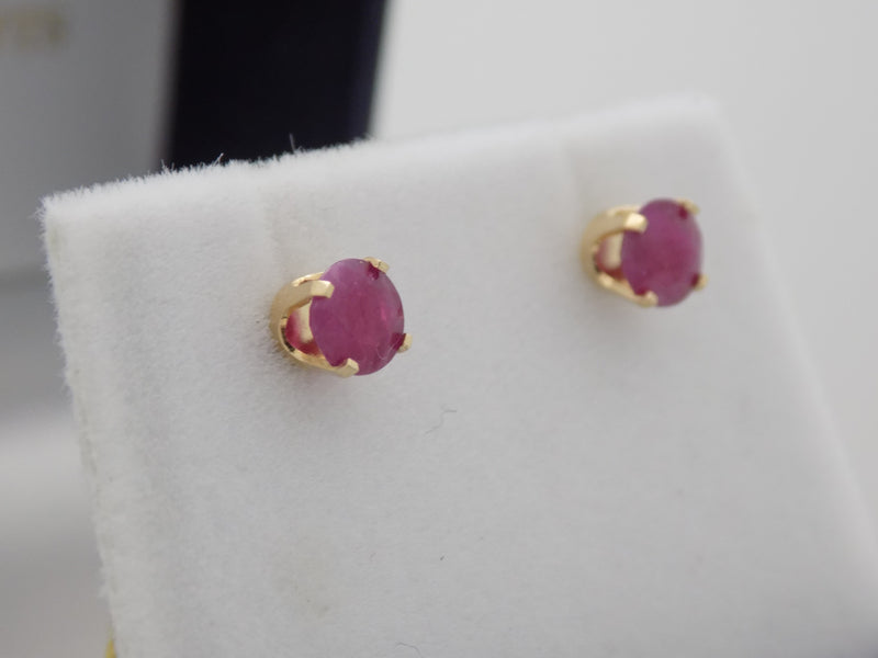 Yellow gold ruby solitaire stud earrings