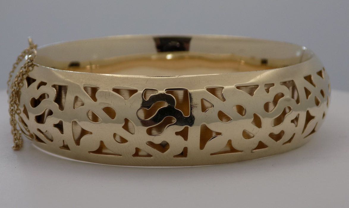 Yellow gold pierced design hinged bangle bracelet