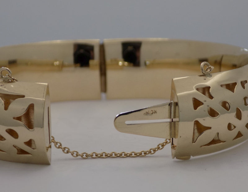 Yellow gold pierced design hinged bangle bracelet