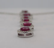 18 karat white gold natural ruby and  diamond halo cascading pendant