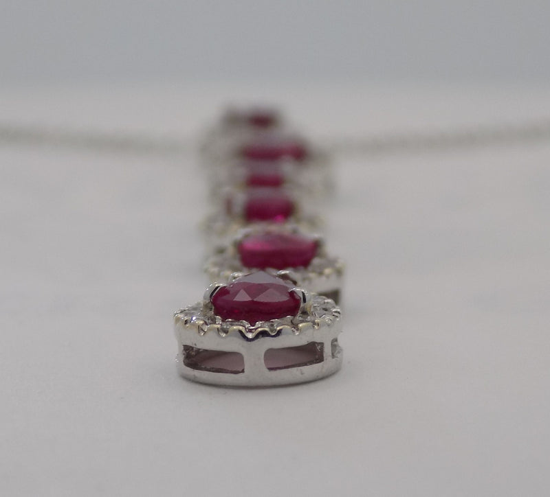 18 karat white gold natural ruby and  diamond halo cascading pendant