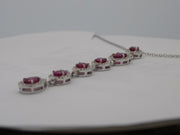 18 karat white gold natural ruby and  diamond halo cascading pendant