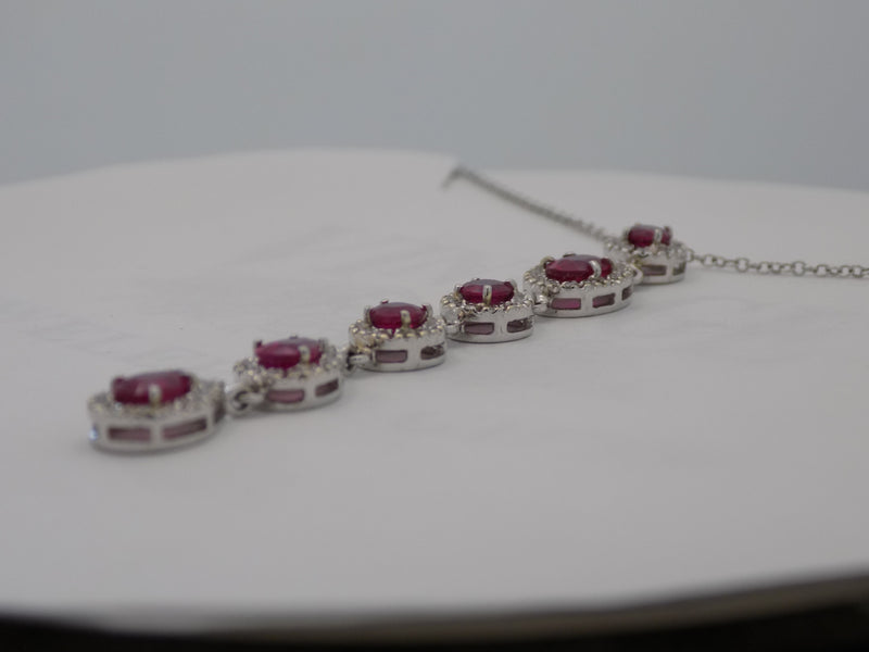 18 karat white gold natural ruby and  diamond halo cascading pendant