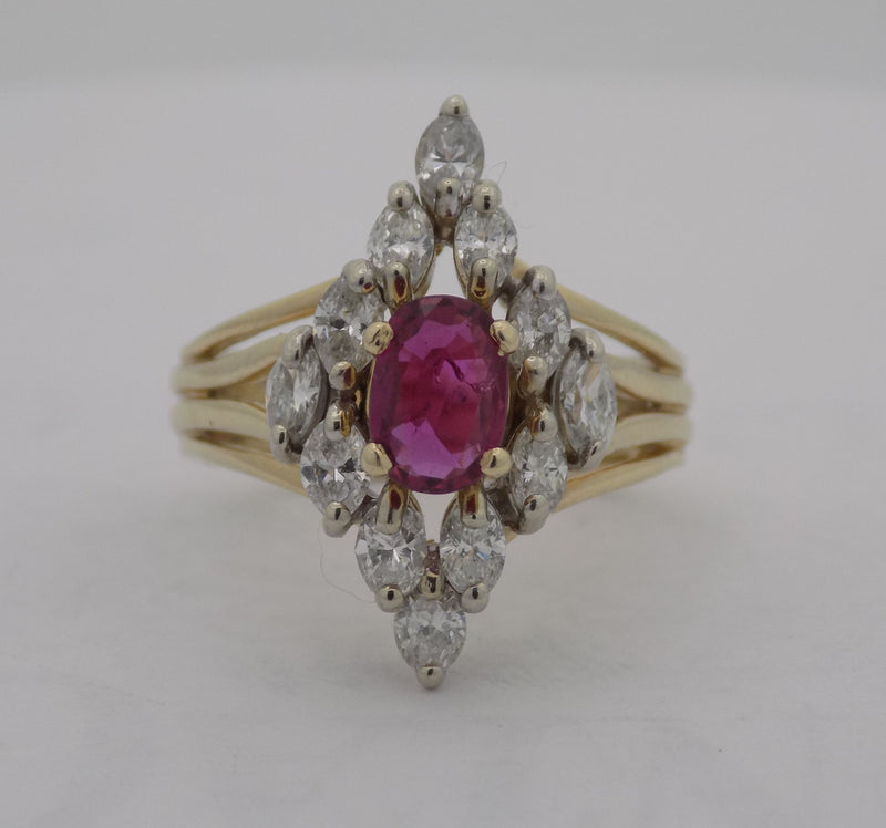 Yellow gold oval ruby marquise diamond cluster ring.