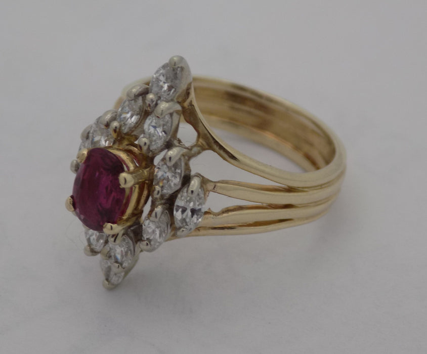 Yellow gold oval ruby marquise diamond cluster ring.
