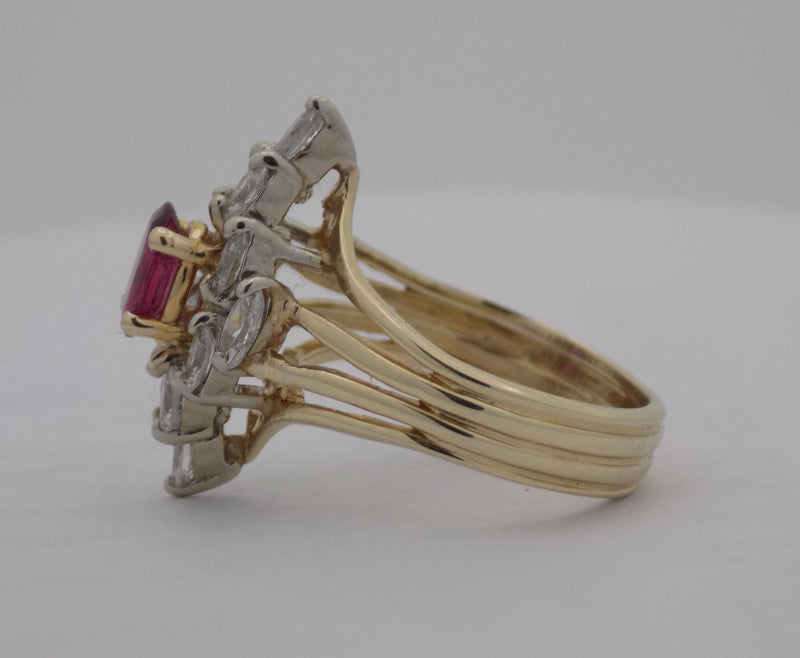 Yellow gold oval ruby marquise diamond cluster ring.