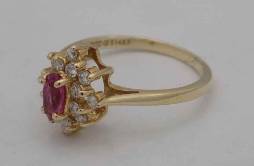 Yellow gold marquise ruby and diamond cluster ring.