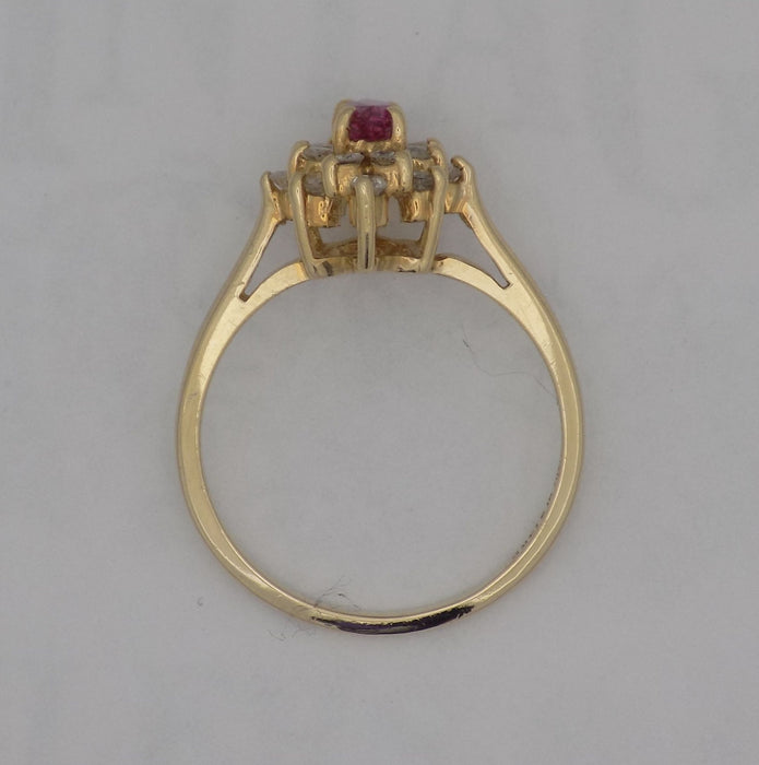 Yellow gold marquise ruby and diamond cluster ring.