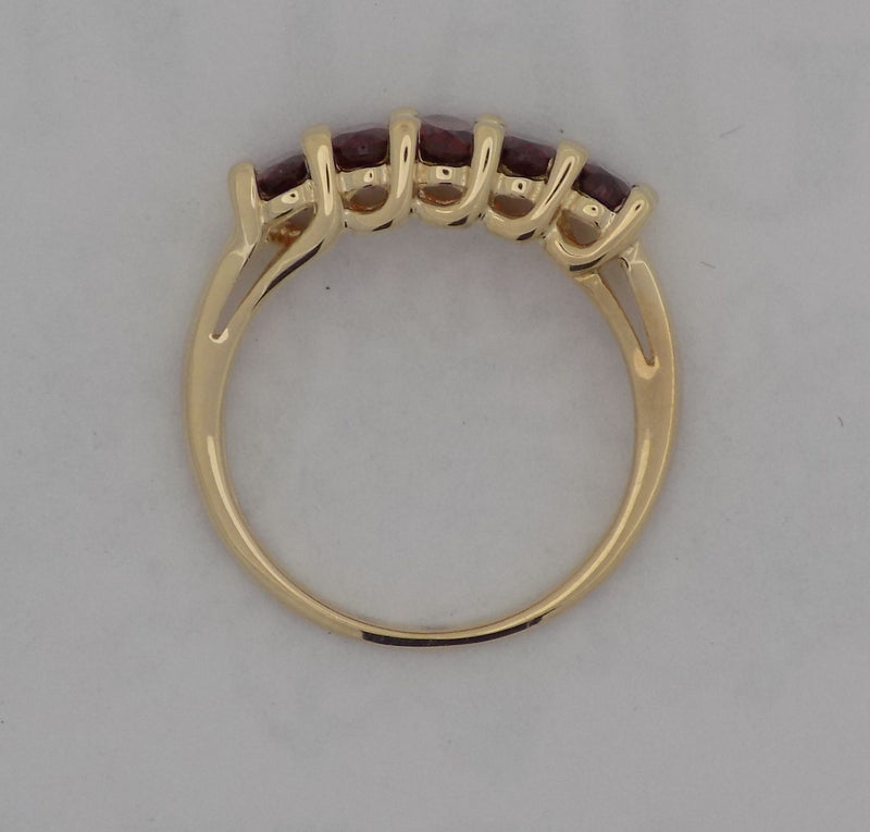 Yellow gold oval garnet band.