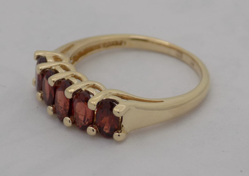 Yellow gold oval garnet band.