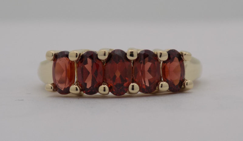 Yellow gold oval garnet band.