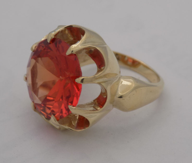 Yellow gold padparadscha sapphire ring.