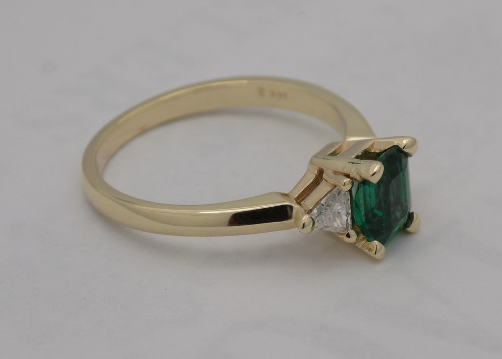 Emerald and diamond yellow gold ring.