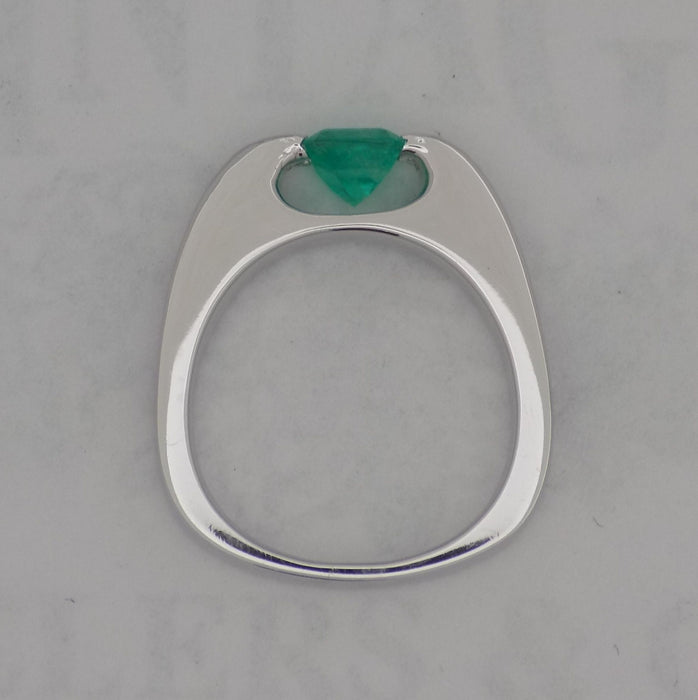 White gold channel set diamond and emerald ring.