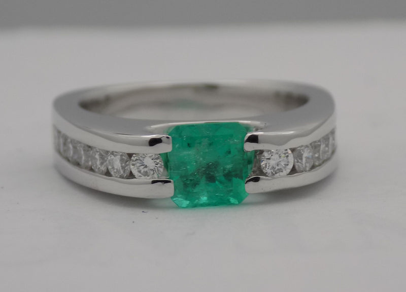 White gold channel set diamond and emerald ring.