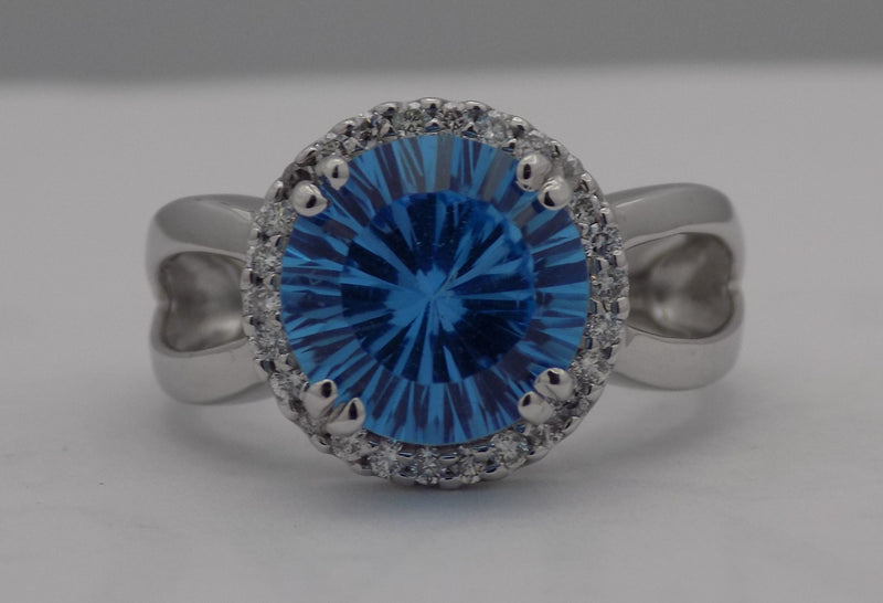White gold blue topaz halo ring.
