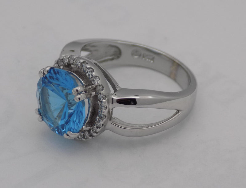 White gold blue topaz halo ring.