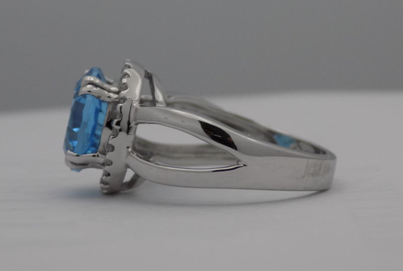 White gold blue topaz halo ring.