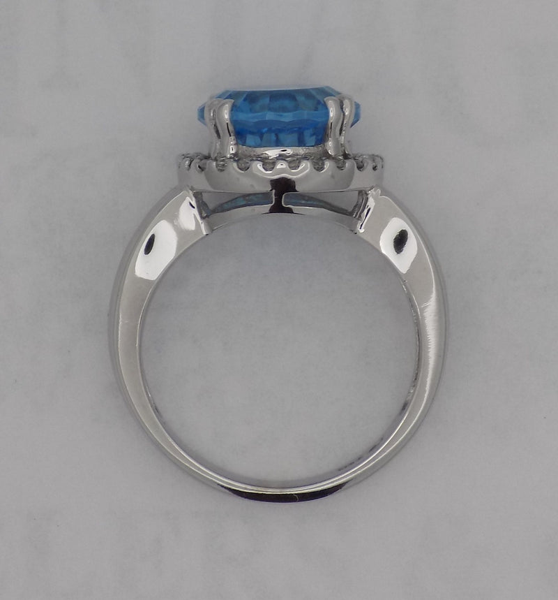 White gold blue topaz halo ring.