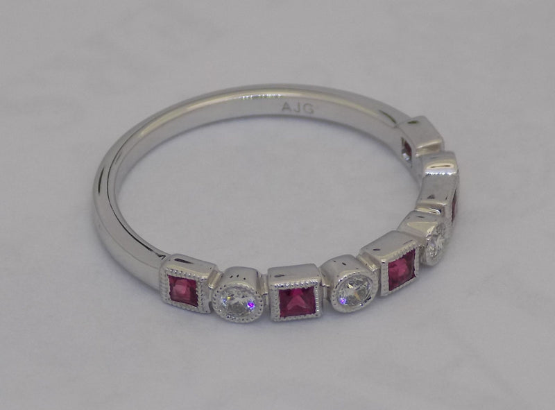White gold square cut ruby and diamond band.