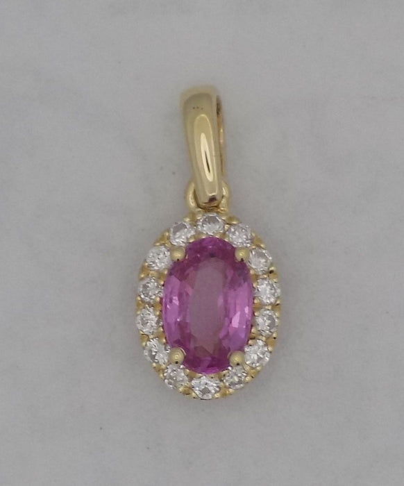 Yellow gold pink sapphire and diamond halo pendant.