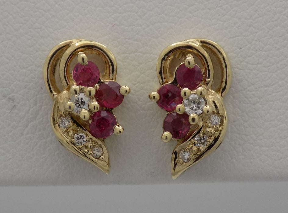 Yellow gold ruby diamond cluster earrings.