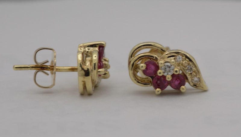 Yellow gold ruby diamond cluster earrings.