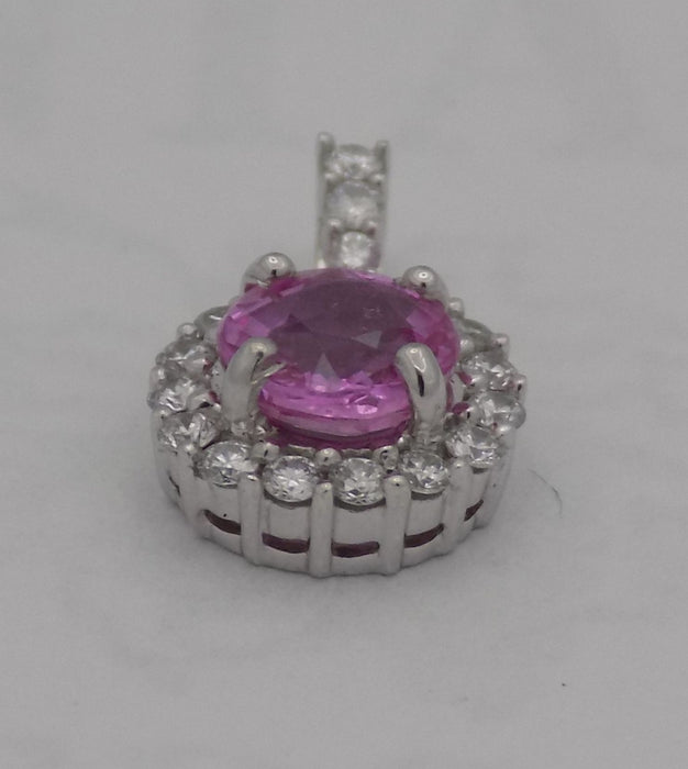 White gold pink sapphire halo diamond pendant.
