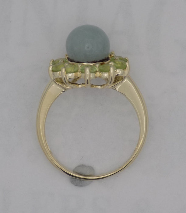 Yellow gold jadeite bead with peridot ring.