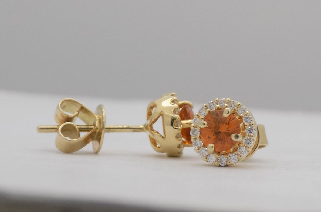 Yellow gold round mandarin garnet stud earrings with diamonds.