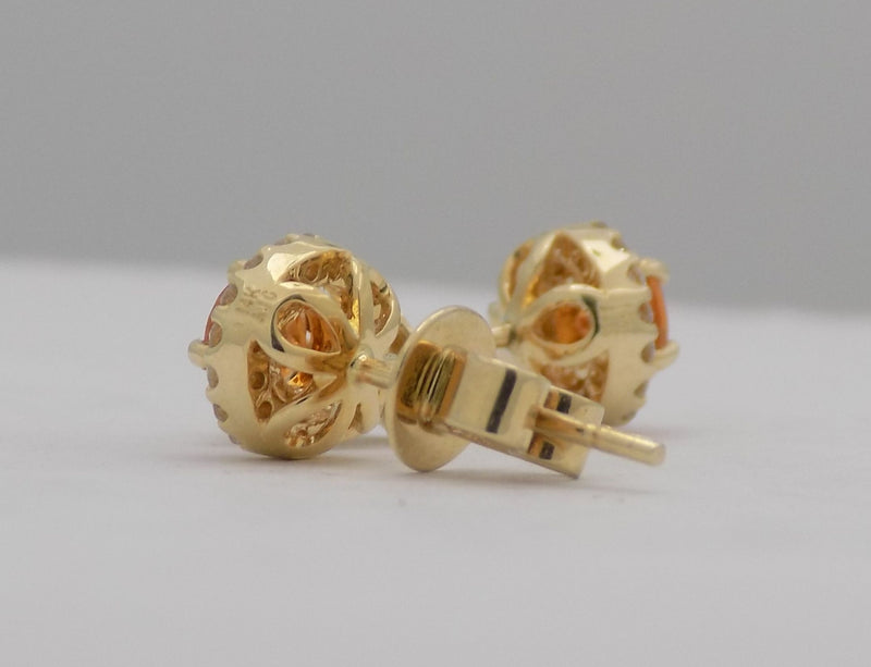 Yellow gold round mandarin garnet stud earrings with diamonds.